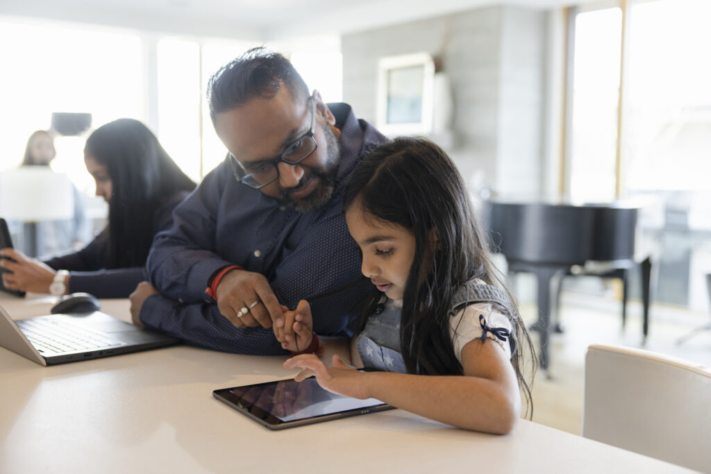 father helping daughter with assignment