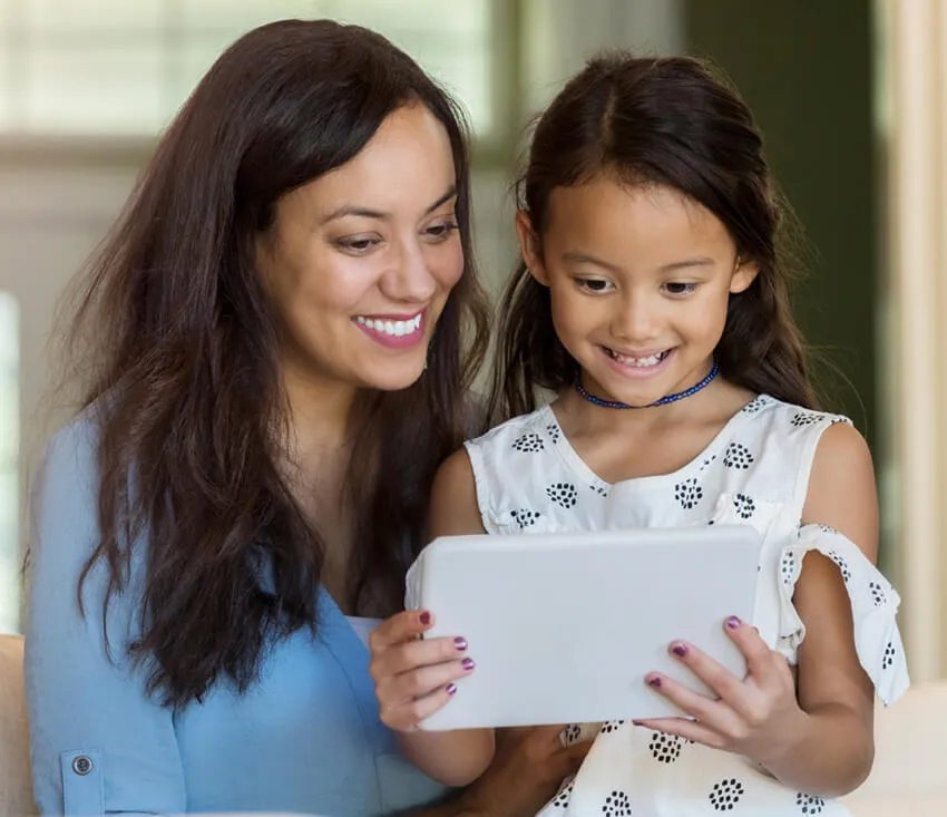 Teacher and student look at tablet