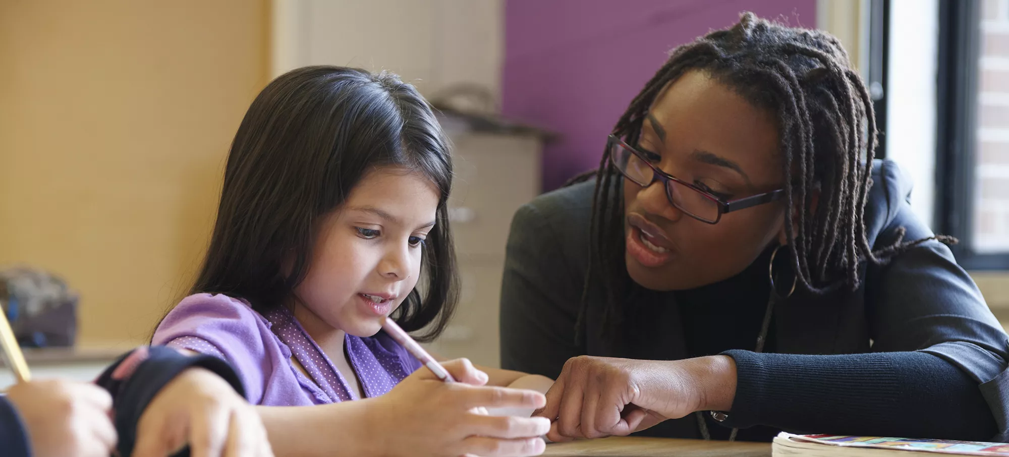 Teacher helping student with school work