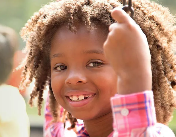 Smiling girl on swing