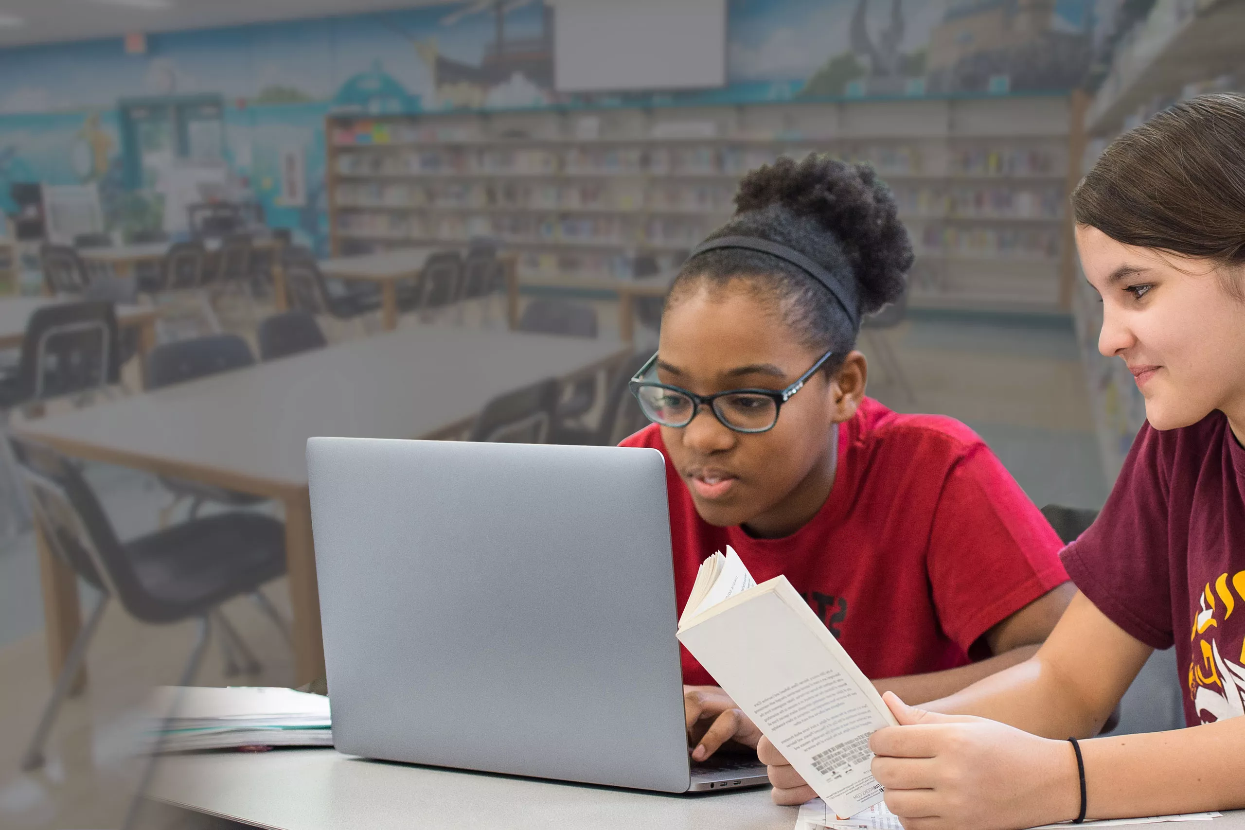 Two female students working on a laptop computer