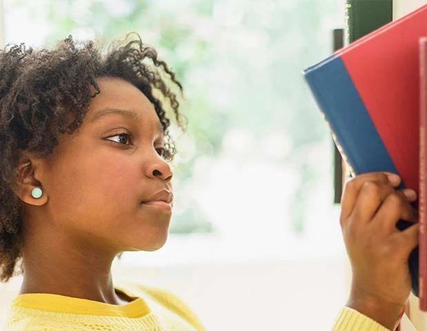 girl reading book for accelerated learning