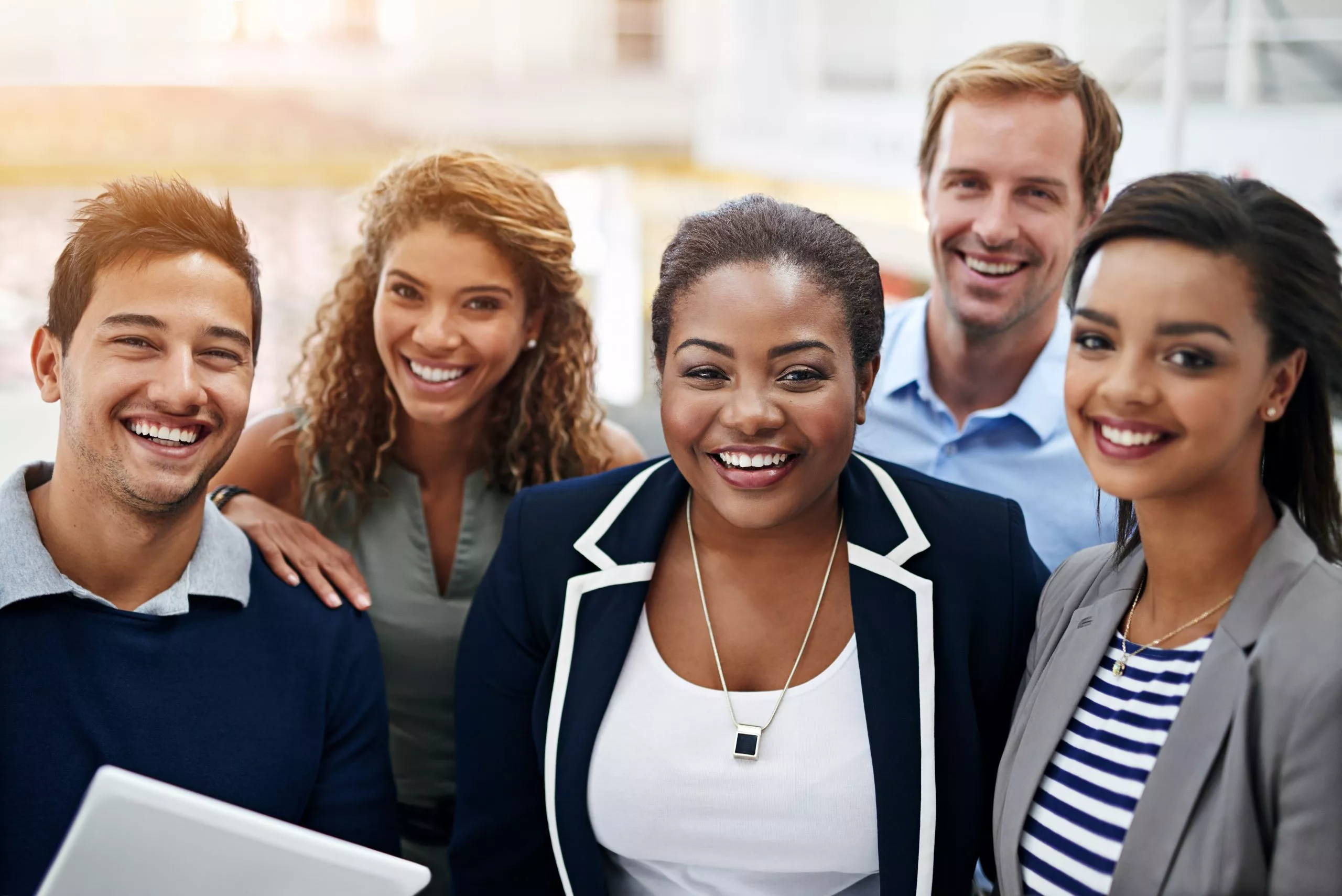 Portrait of a group of smiling coworkers standing in an office