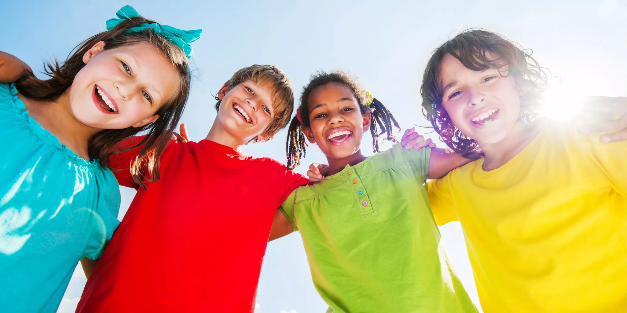 Students smile down at camera