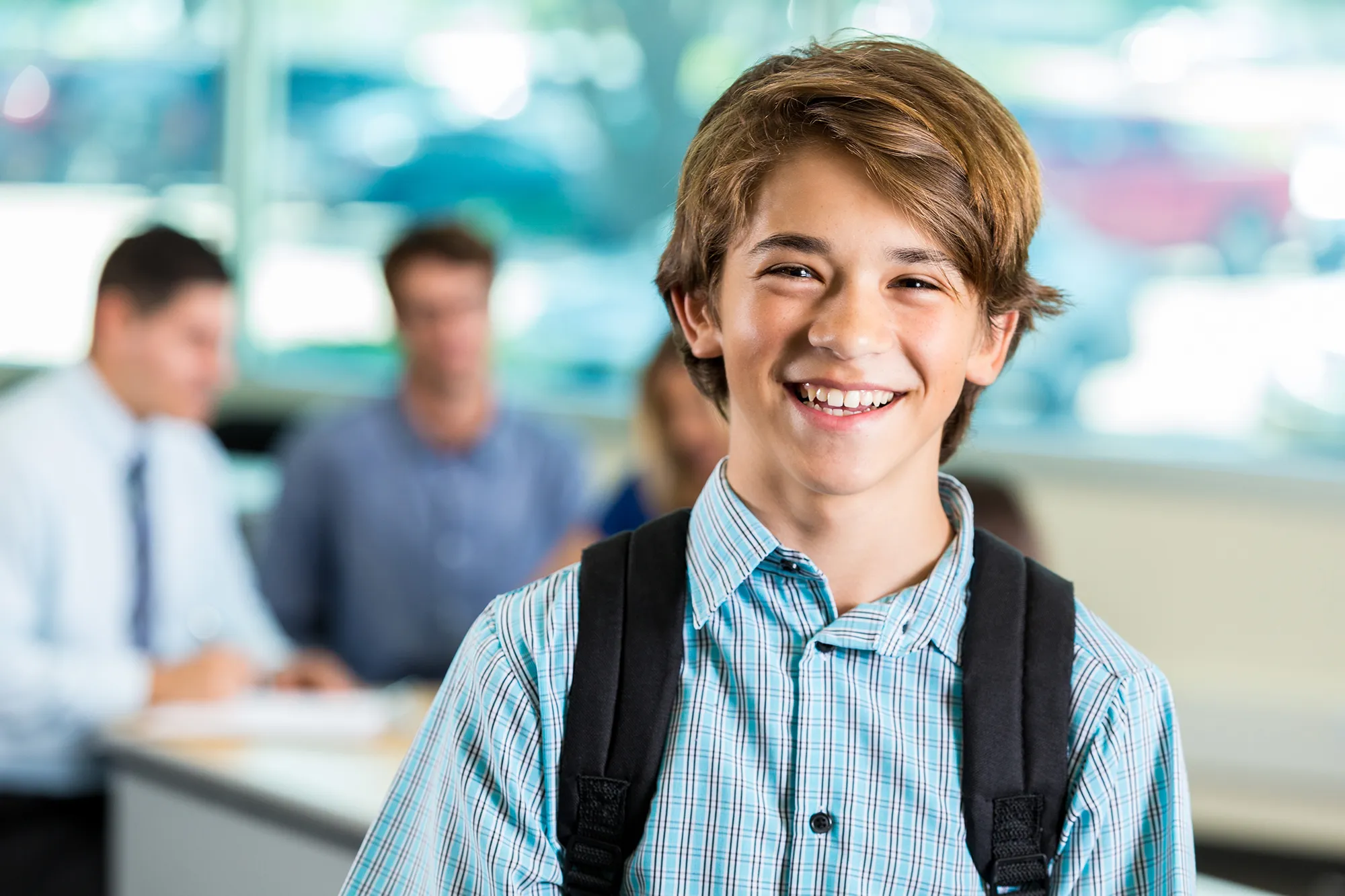 Young male student smiles at camera