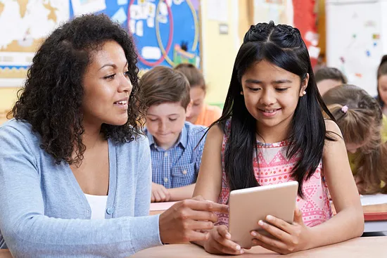 teacher sharing tablet with student