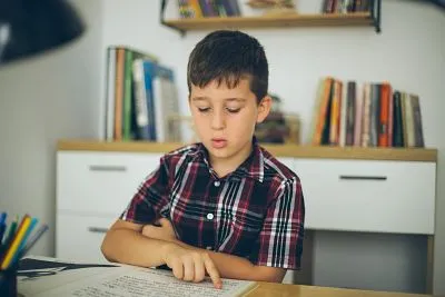 kid reading homework at home
