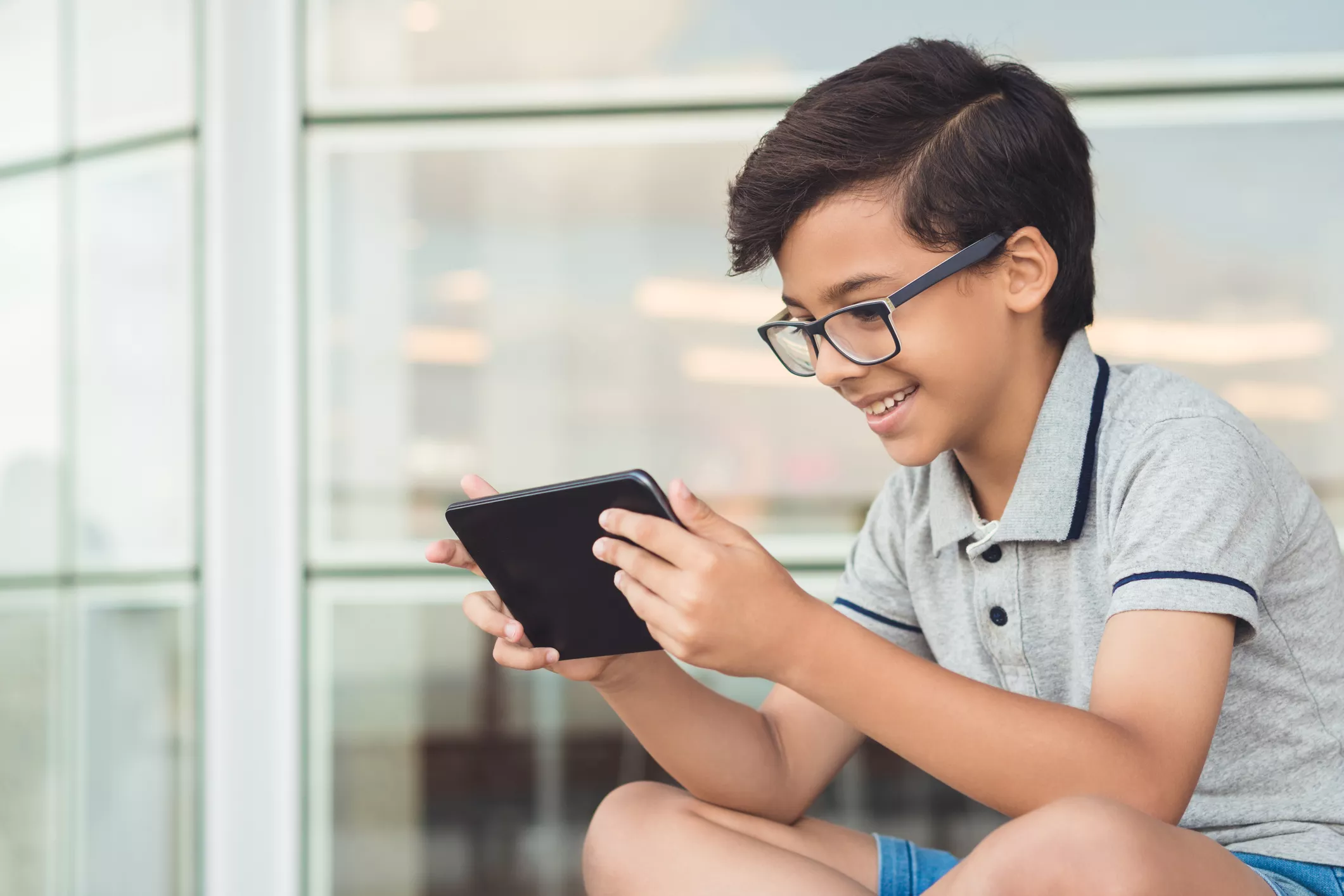 boy focused on tablet