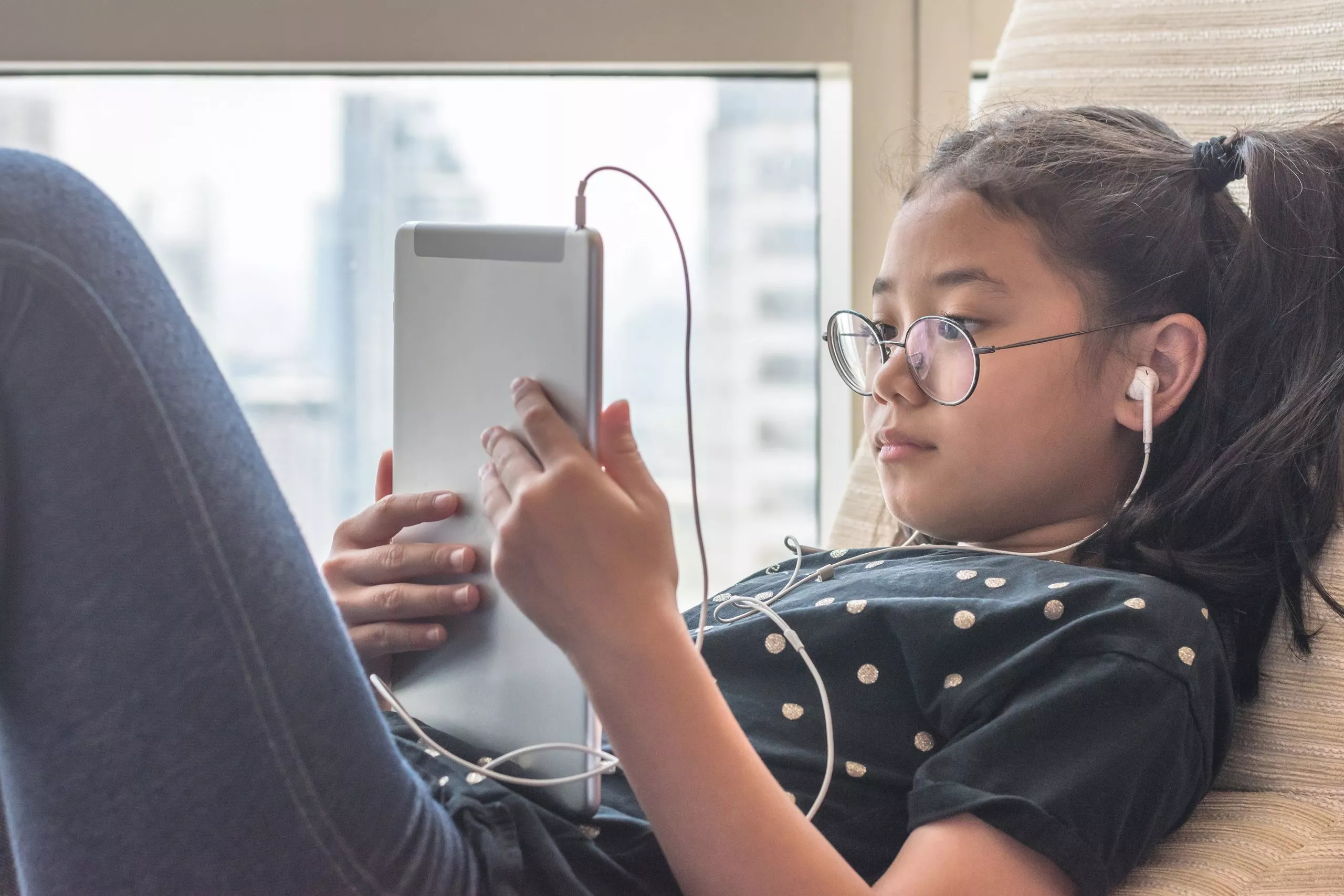 Girl reading on tablet