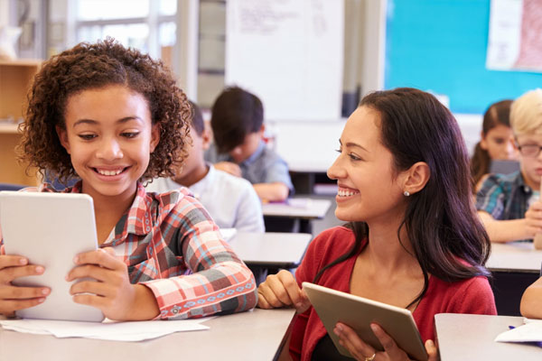 Teacher and girl on tablets