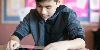 Middle school boy using a tablet
