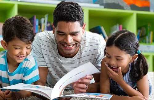 A parent and his children reading