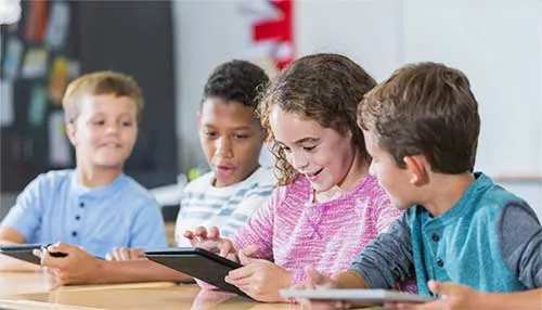 Students look at tablets 