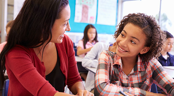 Teacher smiling at a girl