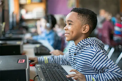 Smiling boy on computer