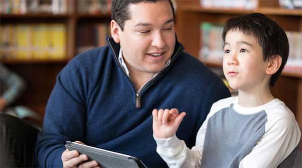 Teacher and boy working on a tablet