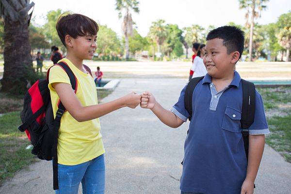 Two boys bumping fists