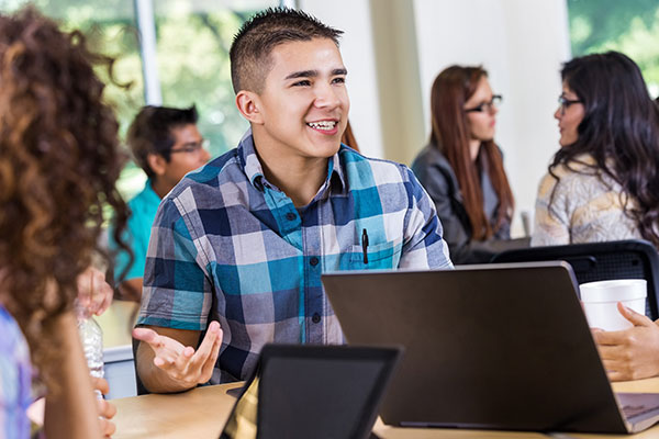 Smiling teen boy in class