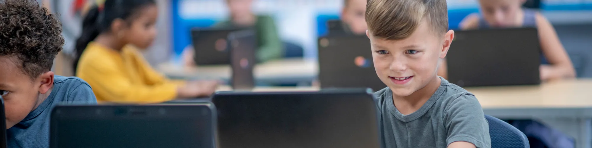 Young boy using Renaissance on a laptop in a classroom