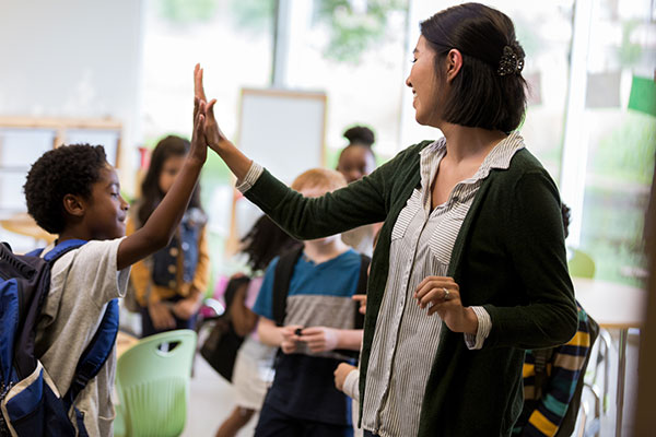 Teacher high-fiving student