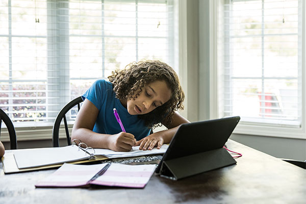 Girl studying at kitchen table