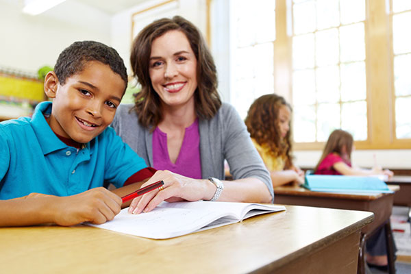 Boy studying with teacher