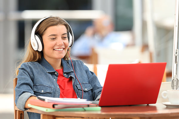 Teen girl with red laptop