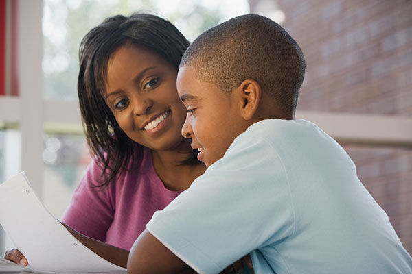 Teacher smiling at boy