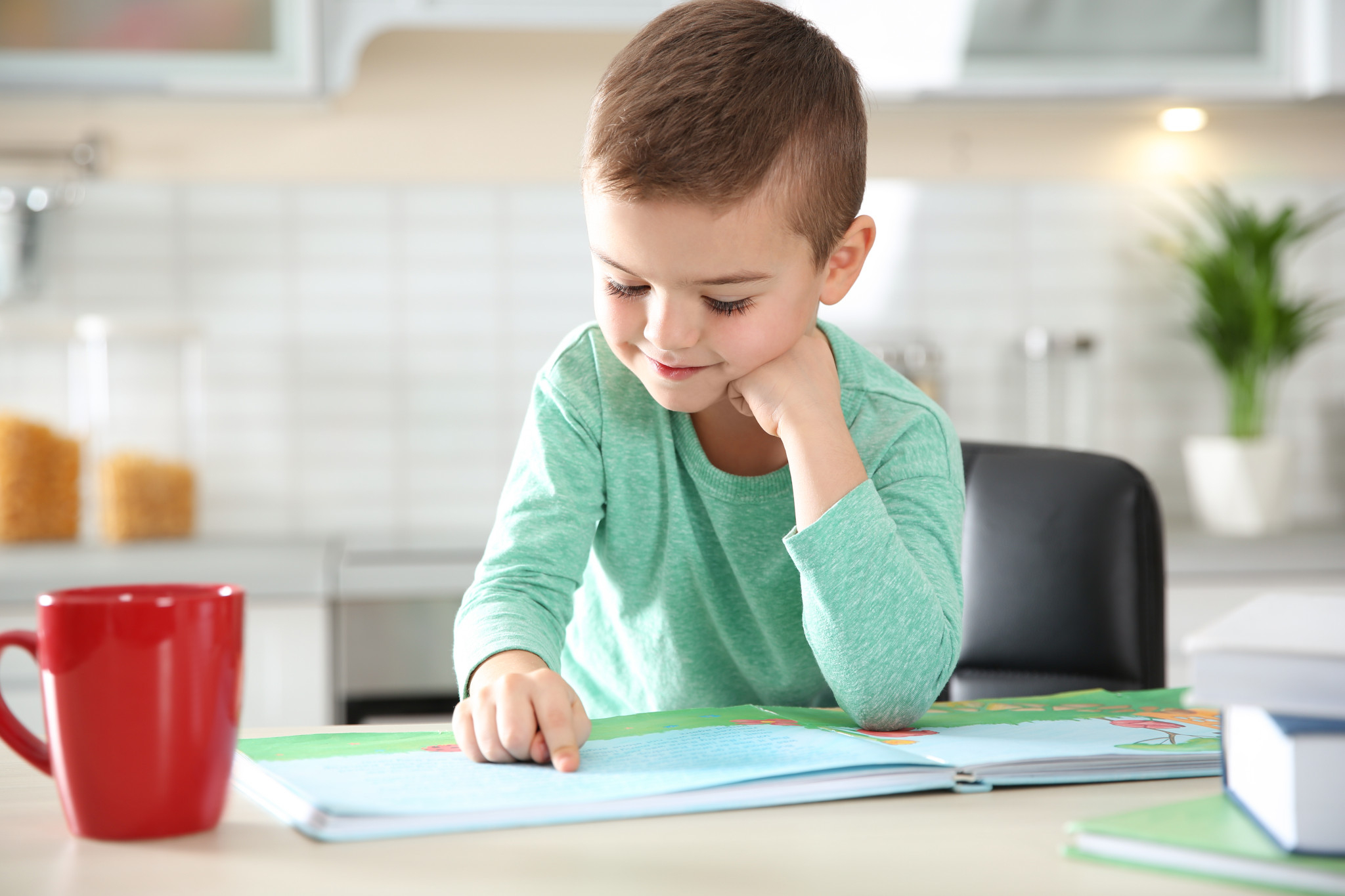 young boy reading book