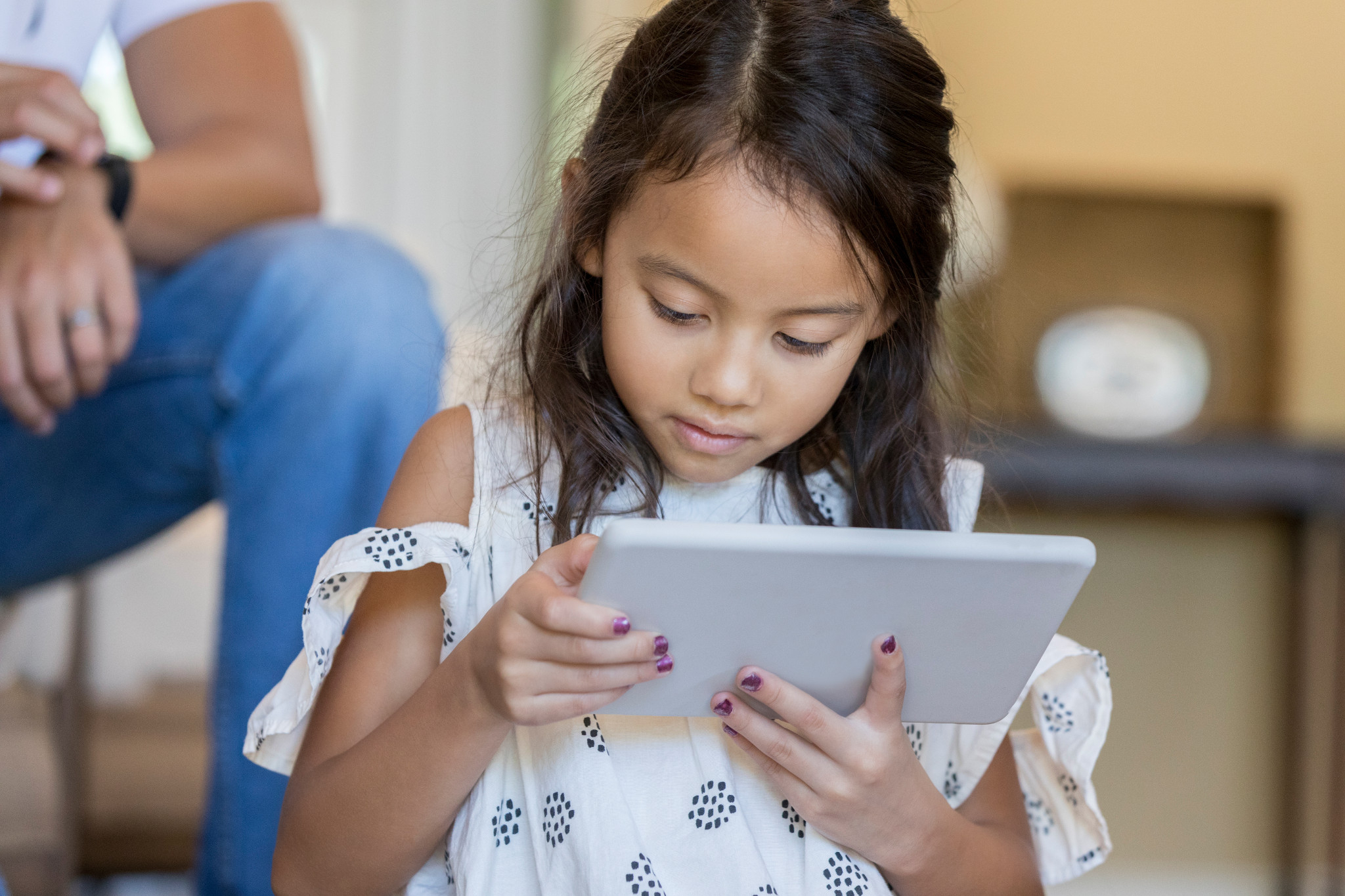 young girl reading on tablet