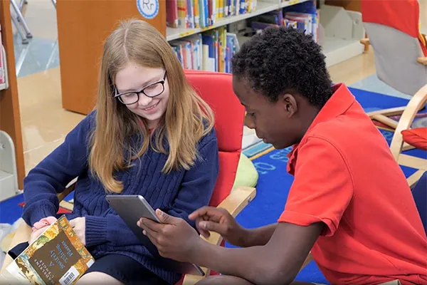 two students looking at a tablet