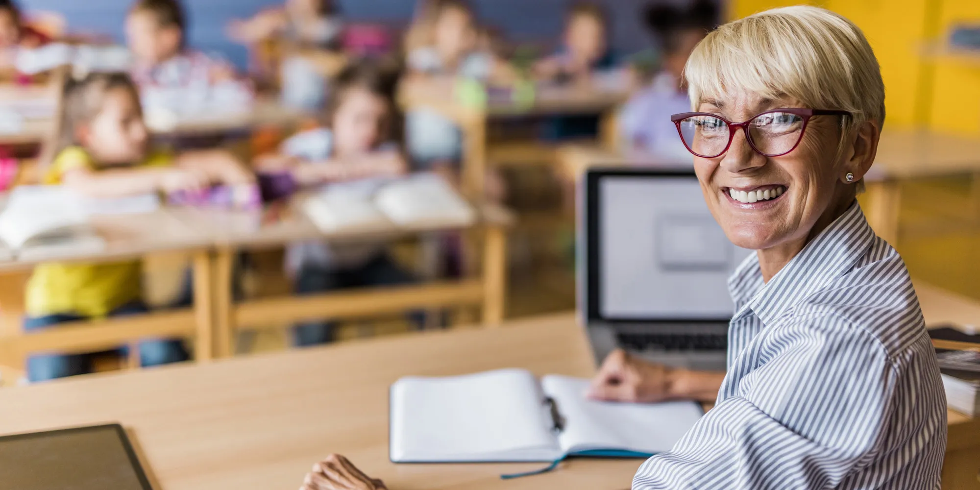 A teacher smiling in her classroom