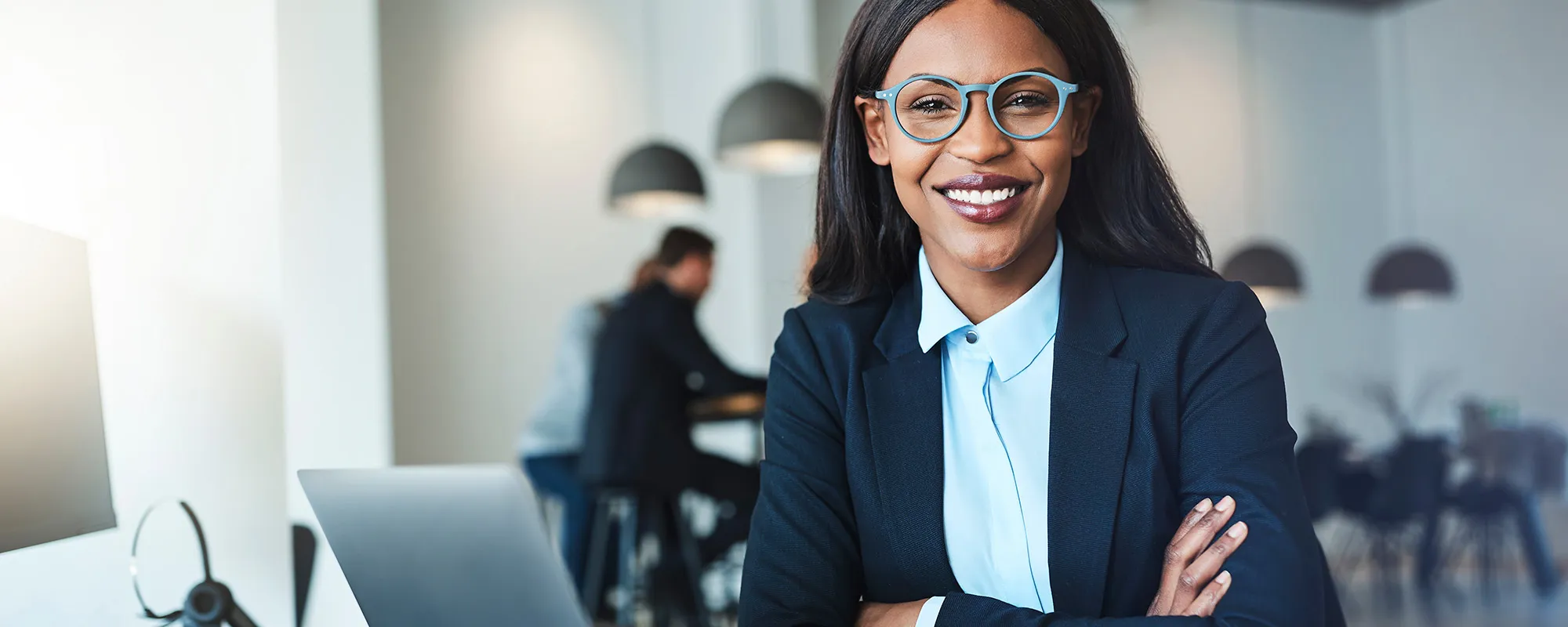 Woman at computer smiling at the camera