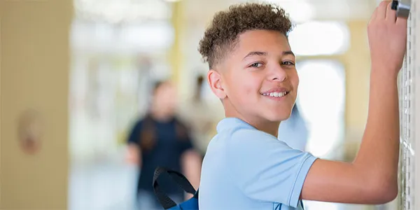 Male student at locker in school