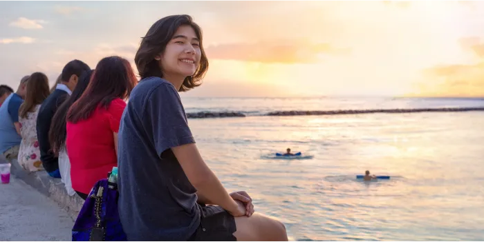 kids sitting by the shore