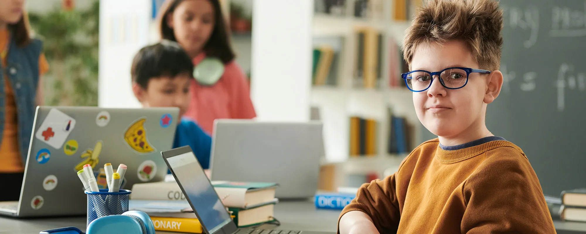 Young male student in a classroom with laptop computers
