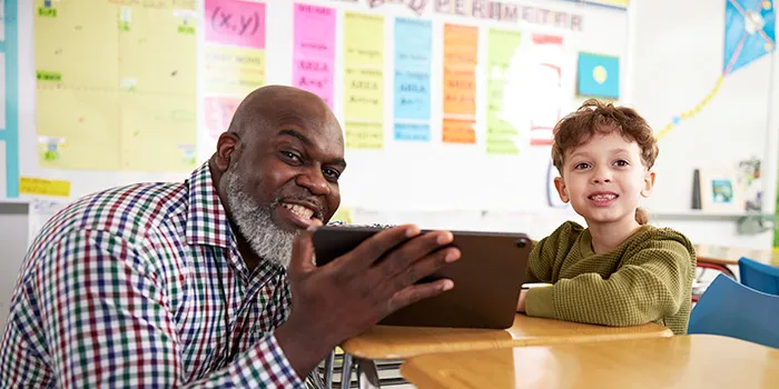 A male teacher and a student using Renaissance Next