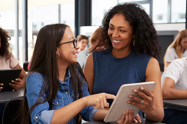 A teacher and student looking at Renaissance Next on a tablet