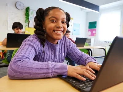 a student sitting at a laptop