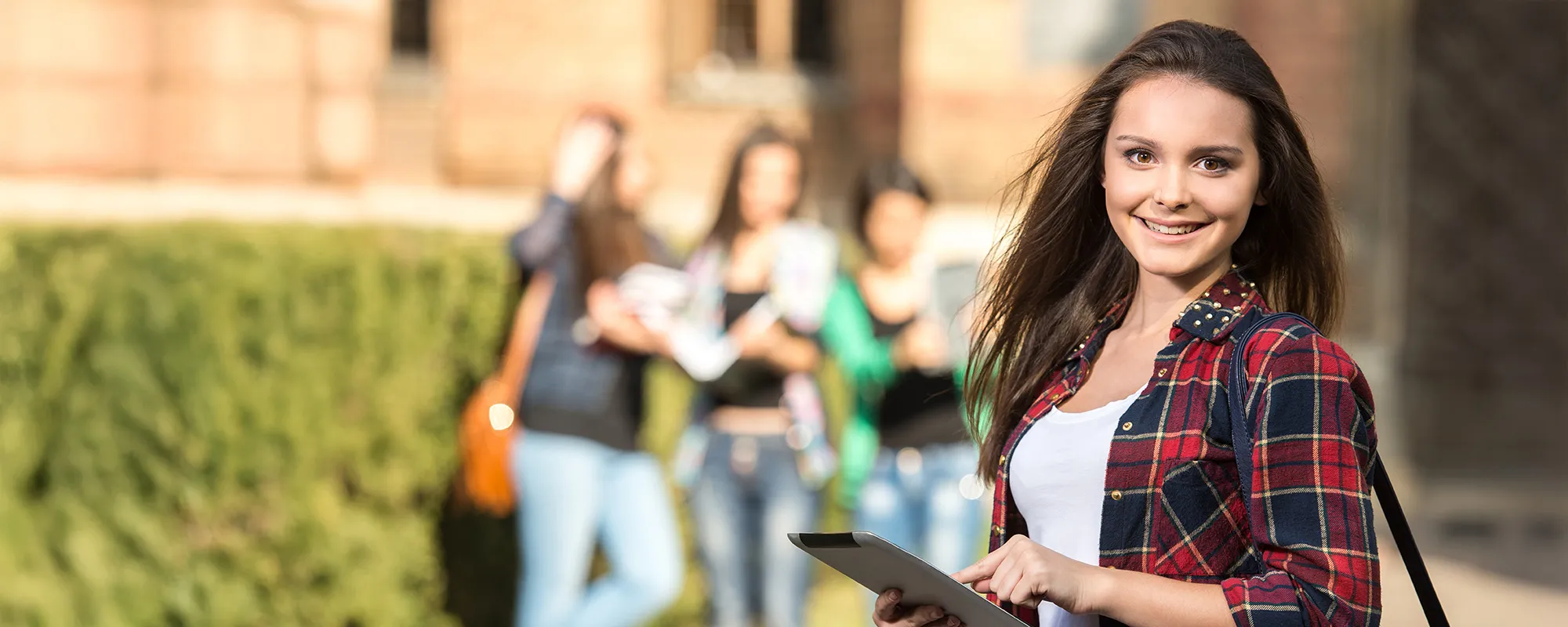 Charter School student holding a digital tablet