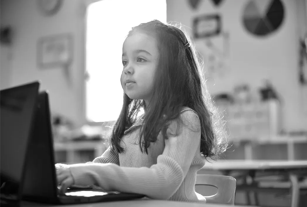 A young girl on a desktop computer doing individualized practice