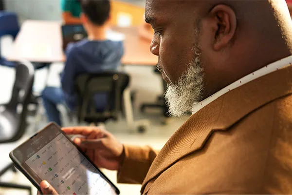 A district administrator using Renaissance Intelligence on a tablet computer
