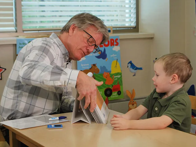 A teacher reviewing lesson with child