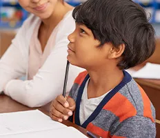 young student in a classroom listening