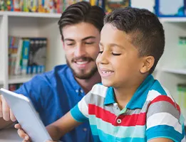 teacher and student reading on a tablet