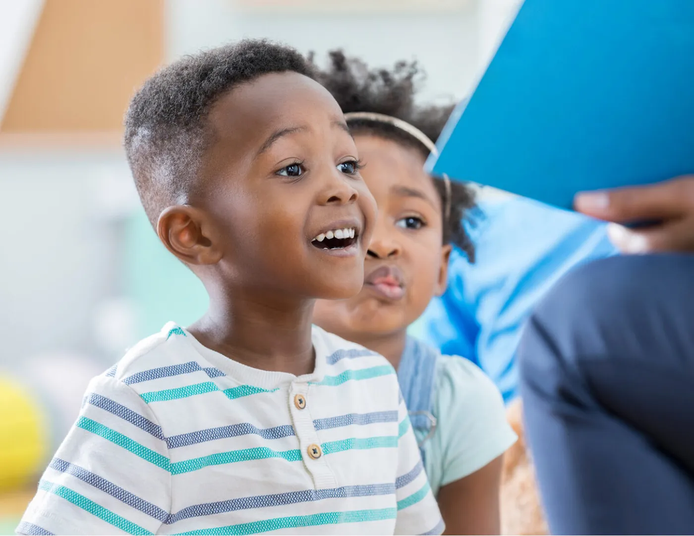 student in classroom with teacher reading