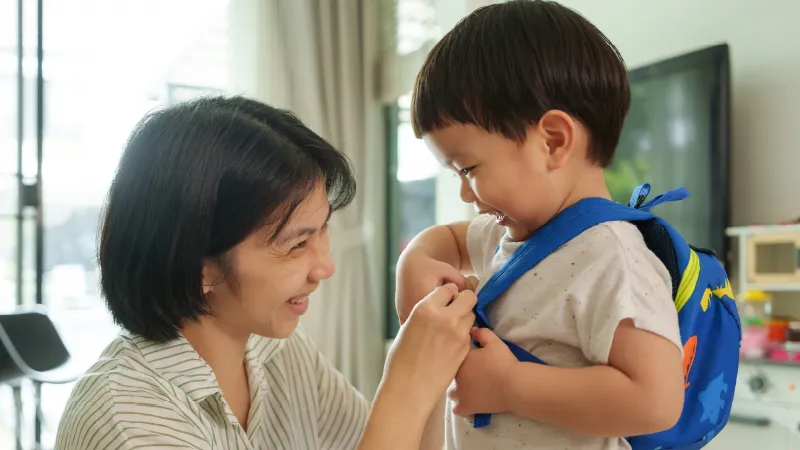 a mom getting her preschooler ready to go to school