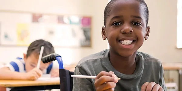 A child at a desk in a classroom