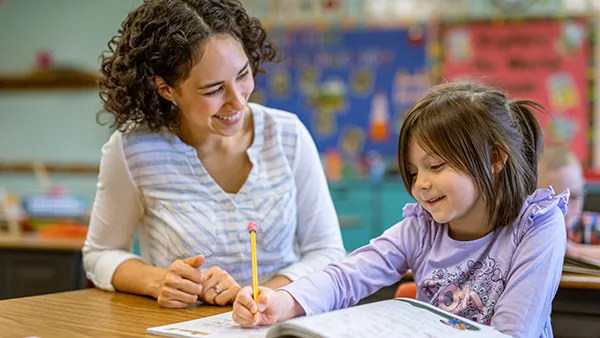 A teacher and a student in a classroom