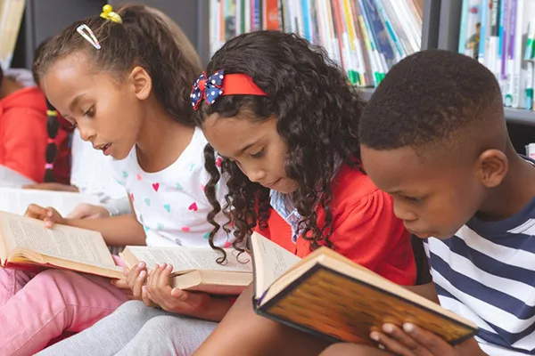 Kids in a library reading